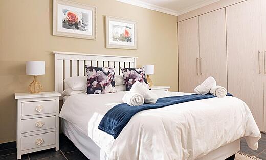 Double bed with towels set out in the 2 bedroom apartment