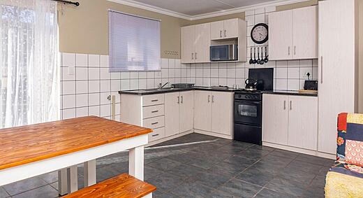 Kitchen and dining area in a Deluxe 2 Bedroom Apartment